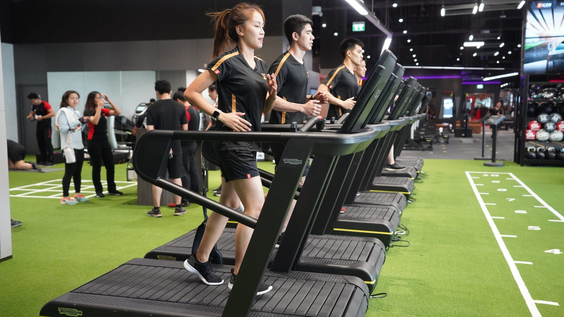 People on treadmills building speed at Fitness First