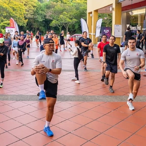 Run Club participants taking part in a warm up drill.