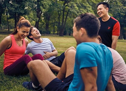 Group of people laughing outdoors.