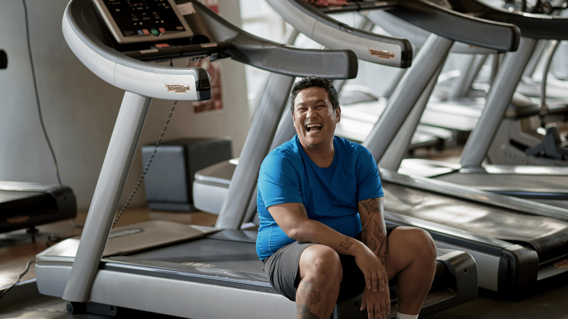 Man taking a rest at the treadmills - Father's Day fitness