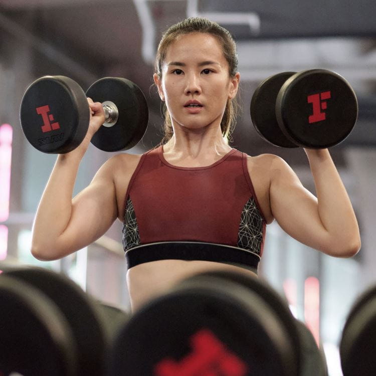 fitness first lifting woman dumbells