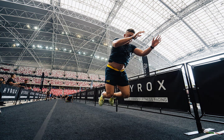 A person jumping burpees in a stadium