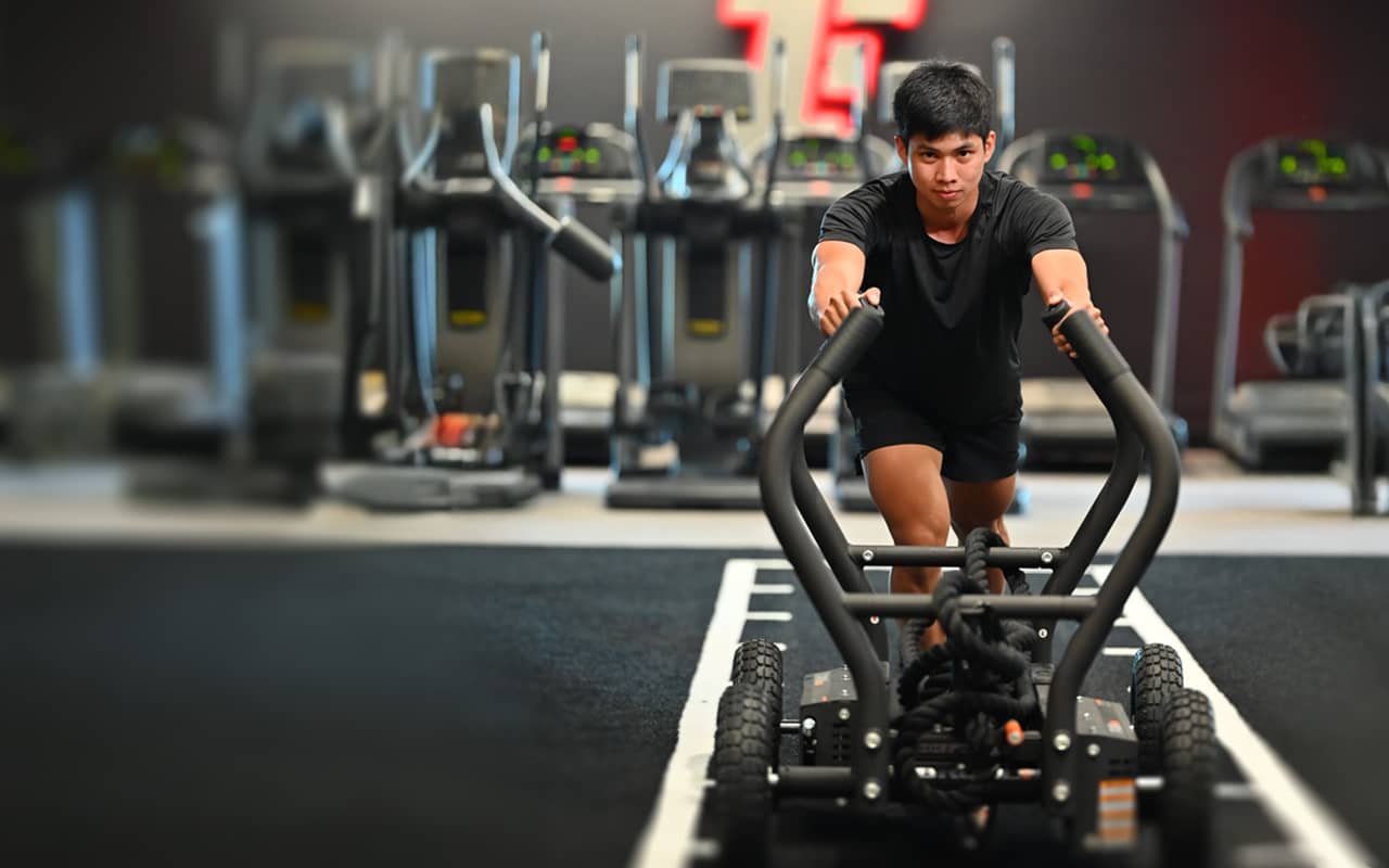 Two people working out with the SkiErg equipment.